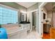 Main bathroom featuring a soaking tub with jets, double vanity, and tile flooring at 1872 Staffwood Rd, Johns Island, SC 29455
