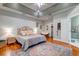 Inviting main bedroom featuring tray ceilings, hardwood floors, ensuite bathroom, and walk-in closet at 1872 Staffwood Rd, Johns Island, SC 29455