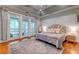 Comfortable main bedroom with tray ceilings, hardwood floors, and a private balcony at 1872 Staffwood Rd, Johns Island, SC 29455