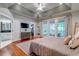 Serene main bedroom featuring tray ceilings, hardwood floors, and access to a private balcony at 1872 Staffwood Rd, Johns Island, SC 29455