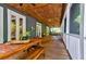 Spacious screened porch with wood ceiling, dining and seating areas at 1872 Staffwood Rd, Johns Island, SC 29455