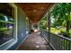 View of the home's exterior porch with a stained wood ceiling, painted gray walls, and wood floors at 1872 Staffwood Rd, Johns Island, SC 29455