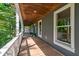 Exterior of the home's long, covered porch with painted wood floors and ceiling, gray walls, and white railings at 1872 Staffwood Rd, Johns Island, SC 29455