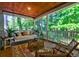 Screened porch featuring a swing and comfortable seating overlooking a lush backyard at 1872 Staffwood Rd, Johns Island, SC 29455
