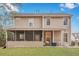 Inviting view of backyard and house with screened in porch, patio, and green lawn at 2004 Hammond Dr, Mount Pleasant, SC 29466