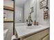 Bathroom vanity featuring matte black faucet, wooden soap dispenser, wood accents, and dark framed mirror at 2004 Hammond Dr, Mount Pleasant, SC 29466