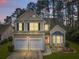 Charming two-story home with a manicured lawn, two-car garage, and welcoming pink front door at 2004 Hammond Dr, Mount Pleasant, SC 29466