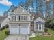 Charming two-story home with a manicured lawn, two-car garage, and welcoming pink front door at 2004 Hammond Dr, Mount Pleasant, SC 29466