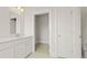 Well-lit bathroom with double sink vanity, closet, white cabinets, and ceramic tile flooring at 205 Bilge Rd, Ridgeville, SC 29472