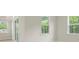 Bright bedroom featuring white trim and windows with natural light and a natural setting outdoors at 205 Bilge Rd, Ridgeville, SC 29472