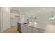 Modern kitchen featuring white cabinets, stainless steel appliances, and a large island with quartz countertops at 205 Bilge Rd, Ridgeville, SC 29472