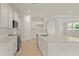Modern kitchen featuring white cabinets, stainless steel appliances, and a large island with quartz countertops at 205 Bilge Rd, Ridgeville, SC 29472