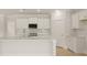 Bright kitchen featuring white cabinets, quartz countertops, stainless steel appliances, and hardwood floors at 205 Bilge Rd, Ridgeville, SC 29472