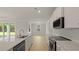 Bright kitchen featuring white cabinets, quartz countertops, stainless steel appliances, and hardwood floors at 205 Bilge Rd, Ridgeville, SC 29472