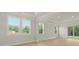 Bright living room with three large windows and sliding glass doors at 205 Bilge Rd, Ridgeville, SC 29472
