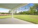 Covered back patio offers views of the expansive green backyard at 214 Bilge Rd, Ridgeville, SC 29472