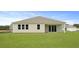 Backyard view showcasing a charming house with lush green lawn at 214 Bilge Rd, Ridgeville, SC 29472