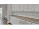 Bright laundry room featuring white cabinets, subway tile backsplash, and light countertop at 214 Bilge Rd, Ridgeville, SC 29472