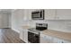 Modern kitchen features white cabinets, stainless steel appliances, granite countertops, and subway tile at 214 Bilge Rd, Ridgeville, SC 29472