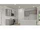 Modern kitchen with gray cabinets, stainless steel appliances and a center island at 214 Bilge Rd, Ridgeville, SC 29472