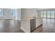 Bright, open kitchen with stainless steel appliances and a modern island, with sliding glass doors nearby at 214 Bilge Rd, Ridgeville, SC 29472