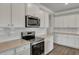 Kitchen with white cabinets, stainless steel appliances, granite counters, and subway tile backsplash at 214 Bilge Rd, Ridgeville, SC 29472