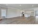 Open-concept kitchen and living space features hardwood floors, granite countertops, and white cabinetry at 214 Bilge Rd, Ridgeville, SC 29472