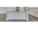 Kitchen island with pendant lighting, stainless steel sink, and gray wood flooring at 214 Bilge Rd, Ridgeville, SC 29472