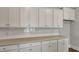 Kitchen features granite countertops, white subway tile backsplash, and white cabinets with modern pulls at 214 Bilge Rd, Ridgeville, SC 29472