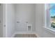 Well-lit laundry room features convenient washer and dryer hookups and a window at 214 Bilge Rd, Ridgeville, SC 29472