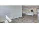 Open-concept living room showcases wood floors and a view into the modern kitchen at 214 Bilge Rd, Ridgeville, SC 29472