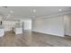 Open-concept living room with wood flooring and white trim, leading to the kitchen area at 214 Bilge Rd, Ridgeville, SC 29472