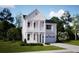 Charming two-story home with a white exterior, classic columns, a balcony, and an attached two car garage at 214 Yalton St, Summerville, SC 29486