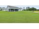 Lush backyard featuring a screened porch, providing a relaxing outdoor space at 215 Bilge Rd, Ridgeville, SC 29472