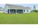 Spacious backyard showcasing a screened porch, ideal for enjoying the outdoors at 215 Bilge Rd, Ridgeville, SC 29472