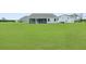 Expansive backyard view featuring a screened-in porch, perfect for outdoor relaxation and entertaining at 215 Bilge Rd, Ridgeville, SC 29472