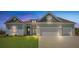 Charming coastal home with a two-car garage and a well-manicured lawn at 215 Bilge Rd, Ridgeville, SC 29472
