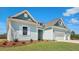 Beautiful one-story home with blue siding, white trim, and a two-car garage at 215 Bilge Rd, Ridgeville, SC 29472