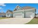 Spacious two-car garage exterior with a concrete driveway and attractive curb appeal at 215 Bilge Rd, Ridgeville, SC 29472