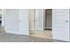 Bright hallway features modern gray flooring and white doors leading to rooms at 215 Bilge Rd, Ridgeville, SC 29472