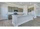 Modern kitchen with gray cabinets, stainless appliances, and a large island with white countertops at 215 Bilge Rd, Ridgeville, SC 29472