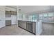 Kitchen island with a stainless steel dishwasher overlooks the living area and backyard at 215 Bilge Rd, Ridgeville, SC 29472