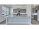 Bright kitchen featuring gray cabinets, stainless appliances, a large island and ample lighting at 215 Bilge Rd, Ridgeville, SC 29472