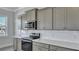 Stylish kitchen featuring gray cabinets, stainless steel appliances, and bright lighting at 215 Bilge Rd, Ridgeville, SC 29472