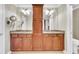 Bathroom featuring dual sinks, granite countertops, and wood cabinetry at 225 Seven Farms Dr # 307, Daniel Island, SC 29492