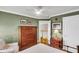 Well lit bedroom featuring hardwood floors, a wrought iron bed frame, and a stately wooden dresser at 225 Seven Farms Dr # 307, Daniel Island, SC 29492