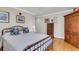 Comfortable bedroom featuring a dresser, side table, light walls, and hardwood floors at 225 Seven Farms Dr # 307, Daniel Island, SC 29492