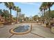 Beautiful community courtyard with a fountain, lush landscaping, and wrought iron details at 225 Seven Farms Dr # 307, Daniel Island, SC 29492