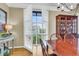 Dining room with views featuring a table with chairs, display cabinet and shuttered window at 225 Seven Farms Dr # 307, Daniel Island, SC 29492