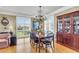 Dining room with chandelier, plantation shutters, hardwood floors, and classic furniture at 225 Seven Farms Dr # 307, Daniel Island, SC 29492